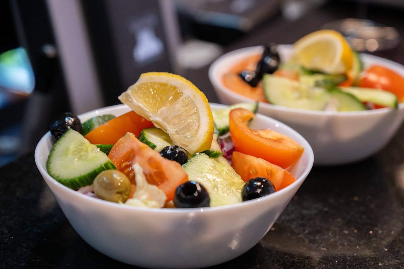 Greek side salad with olives, cucumber, tomato and lemon