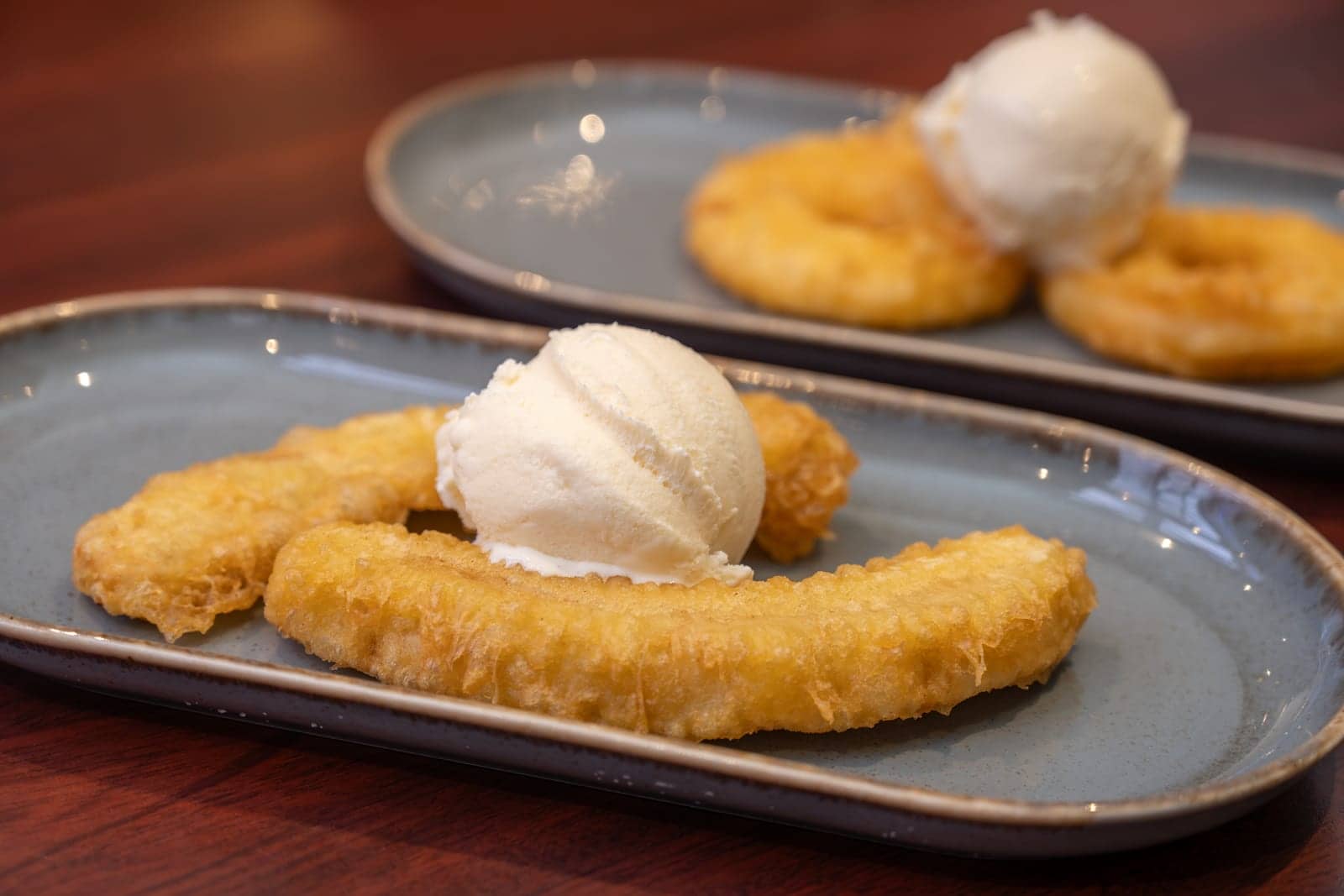 Homemade pineapple fritters with a scoop of vanilla ice cream